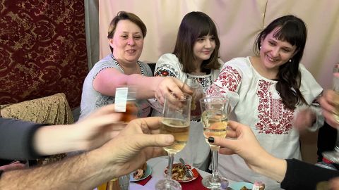 Elena Molchanova, a specialist in infectious diseases on the left and neurosurgeon Elena Manukhina on the right, two of the remaining seven doctors in Bakhmut, toasting over Christmas dinner.