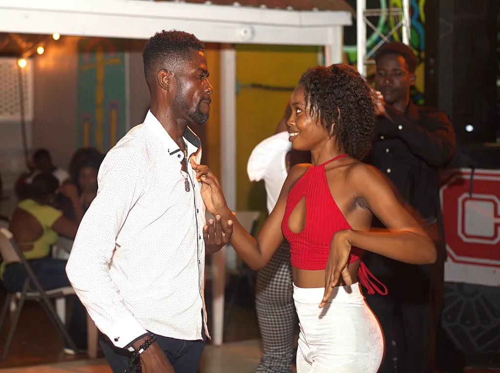 A woman affectionately looks at her dance partner as the two enjoy each other’s company at Lakay Restaurant in Cap-Haïtien on October 2, 2025. Photo by Onz Chéry/ The Haitian Times