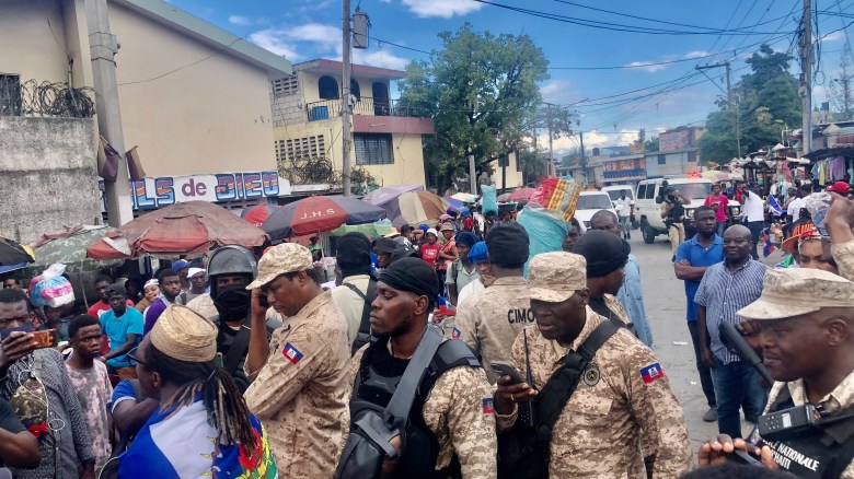 Faithfuls wearing shirts from Pastor Marco’s church and holding the national flag while singing and dancing during the march for peace in Port-au-Prince on Saturday, Jan. 3, 2026. Photo by Juhakenson Blaise / The Haitian Times
