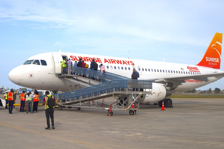 Travelers board Sunrise Airways’ Boeing 737 aircraft during the airline's inaugural Cap-Haïtien-Boston flight at the Hugo Chavez Cap-Haïtien International Airport on March 17, 2026. Photo by Onz Chéry/ The Haitian Times