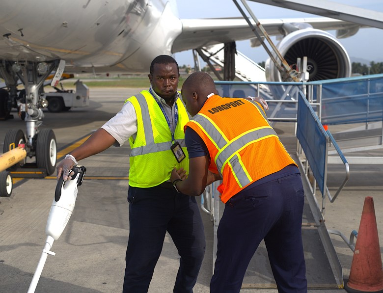 An airport employee undergoes a security check before assisting with flight preparations. Photo by Onz Chéry/The Haitian Times.